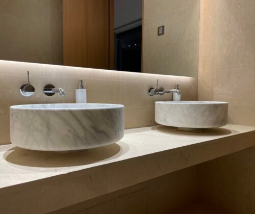Modern bathroom with marble vessel sinks and wall-mounted fixtures at AM Villa