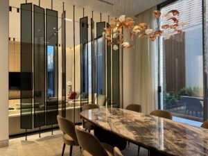 Luxury dining area with marble table and glass partitions
