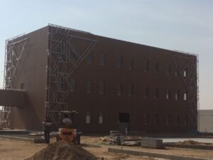 Large school building exterior Decorative metal facade under construction