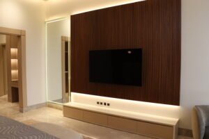 luxury villa -TV wall with integrated LED lighting, wooden paneling and concealed electrical setup
