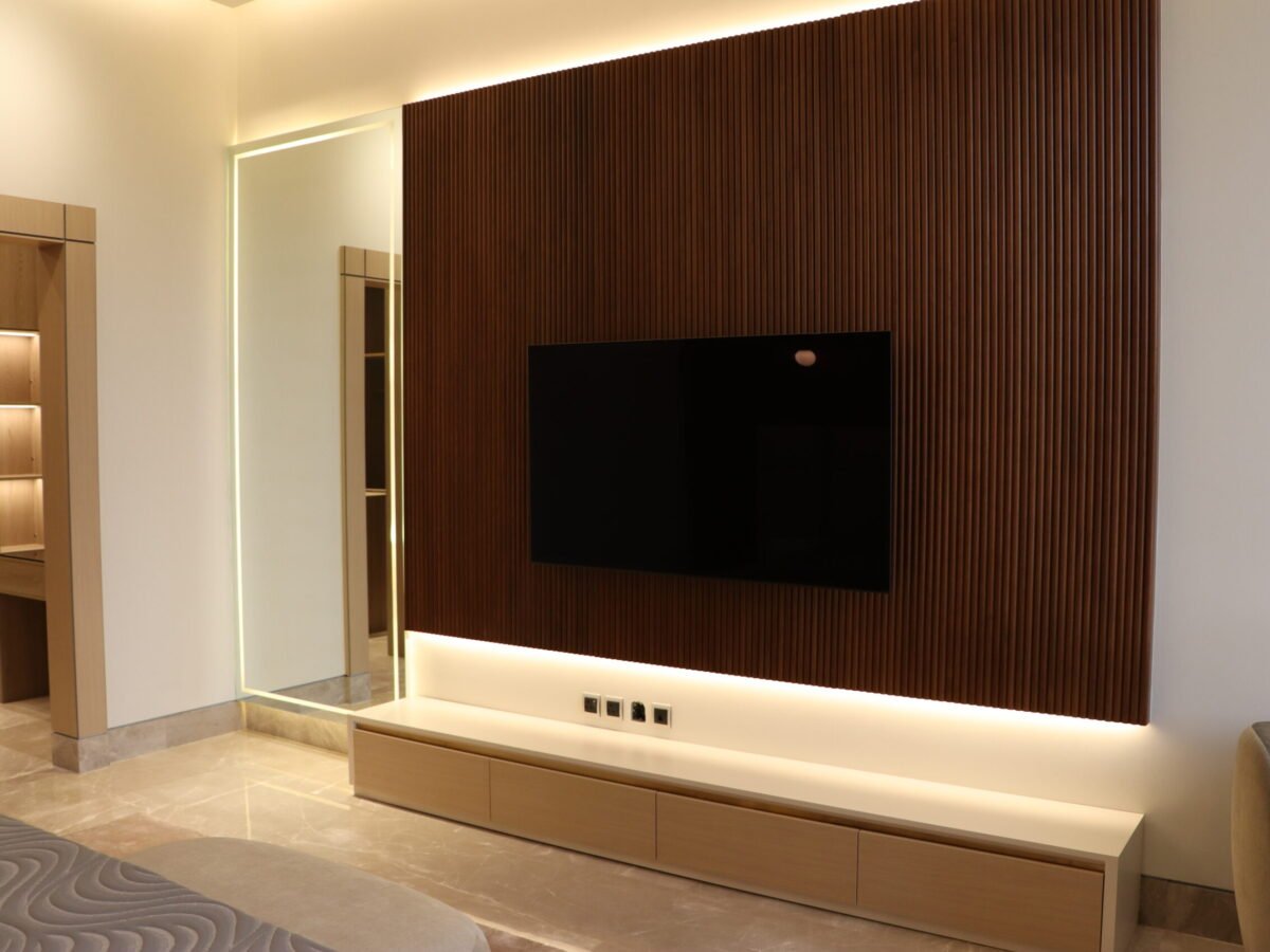 luxury villa -TV wall with integrated LED lighting, wooden paneling and concealed electrical setup