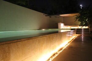 Outdoor poolside lighting with linear LED strip at night