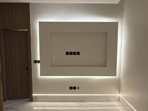 Luxury villa TV wall unit with backlit panel design and marble flooring interior