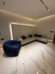 Luxury villa living room with modern sofa seating and ambient lighting interior design ( residential construction project saudi arabia)