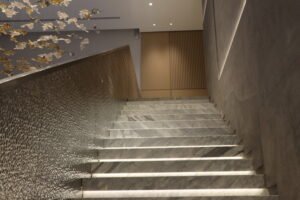 Modern interior staircase with marble steps and soft lighting