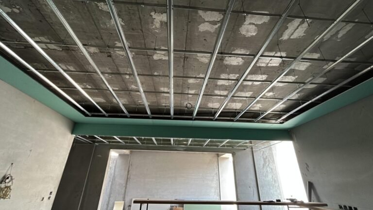 Galvanised steel ceiling frame hung from the concrete slab, with gypsum boards being fixed