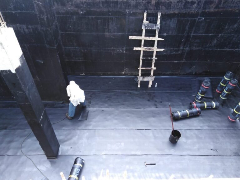 Bitumen membrane laid on the basement floor and walls, with membrane rolls ready on site