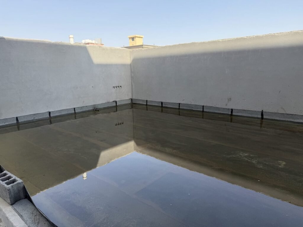 Roof flood test: water standing over the membrane, which is turned up the parapet walls